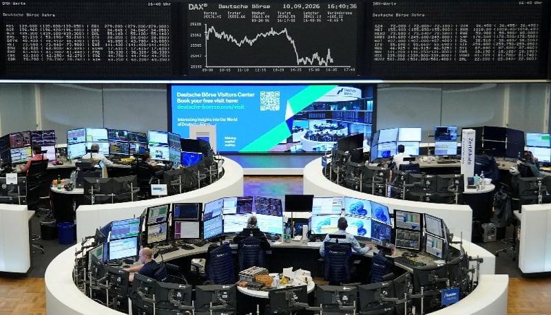 Các nhà giao dịch làm việc tại Sở Giao dịch chứng khoán Frankfurt, Đức, với bảng điện tử hiển thị chỉ số DAX. Ảnh: Reuters